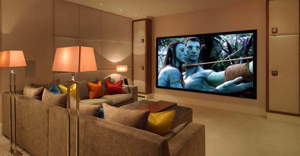 A basement home cinema with surround sound and subtle acoustic treatments.