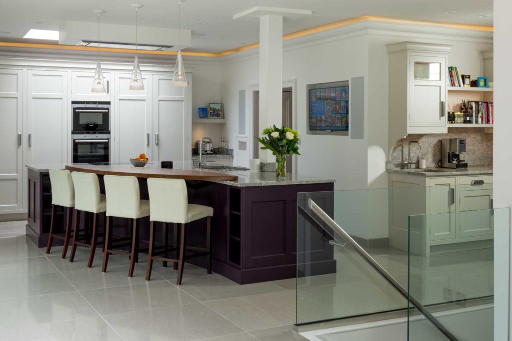 A kitchen diner with wall mounted television, in-wall loudspeakers and lighting control.