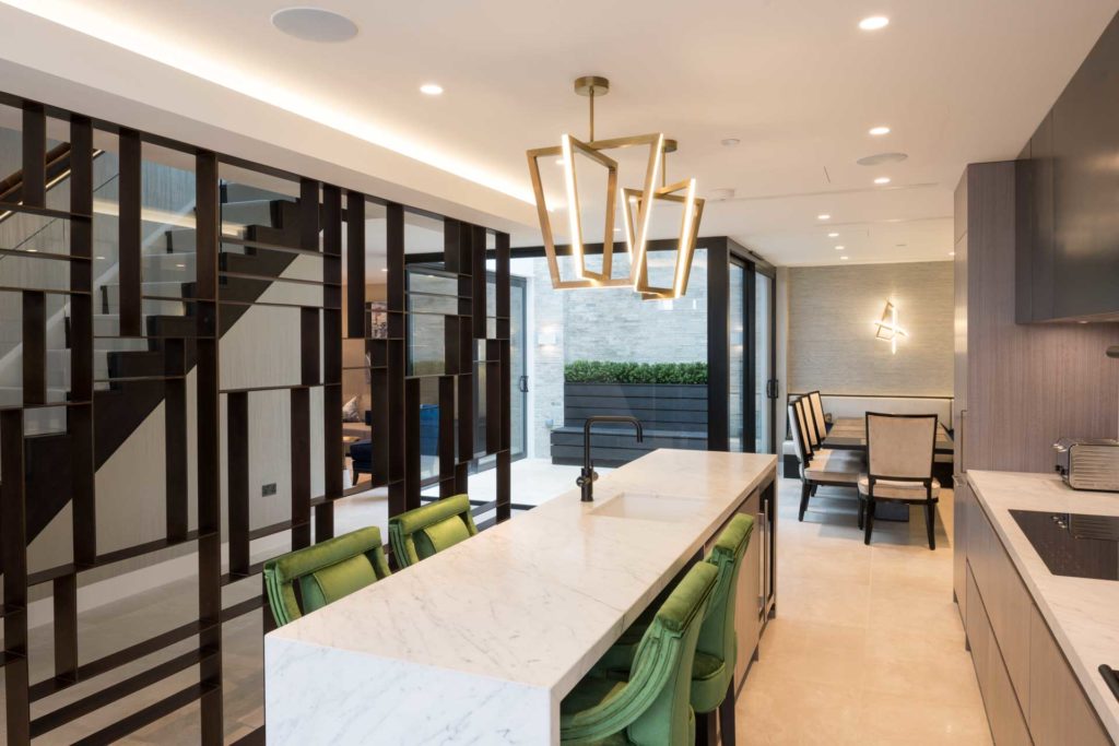 A kitchen dining area with luxurious lighting and discreet audio.
