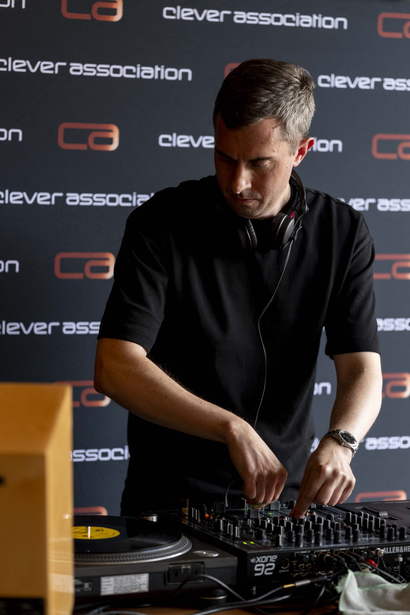 A DJ mixing records at the Clever Association Summer Soiree